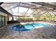 Inviting screened pool area with brick-paved patio, and seamless access to outdoor living at 9805 Hermosillo Dr, New Port Richey, FL 34655