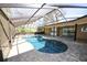 Private, screened pool with brick paver deck and seamless access to indoor and outdoor living at 9805 Hermosillo Dr, New Port Richey, FL 34655