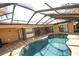 Beautiful outdoor pool area, perfect for relaxation and entertaining, with a screened in enclosure and plenty of patio space at 9805 Hermosillo Dr, New Port Richey, FL 34655