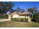 Relaxing side exterior view of home with manicured shrubbery and brick paver driveway at 9805 Hermosillo Dr, New Port Richey, FL 34655