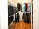 Walk-in closet with ample storage and organized hanging rods for clothes at 9805 Hermosillo Dr, New Port Richey, FL 34655