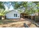 Backyard features partially-covered patio with brick pavers, lawn and privacy fence at 902 Estelle Ave, Brandon, FL 33511