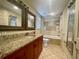 Bathroom featuring granite countertop vanity and shower-tub combo at 902 Estelle Ave, Brandon, FL 33511