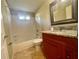 Bathroom features decorative granite countertops, large mirror, and tub with shower at 902 Estelle Ave, Brandon, FL 33511