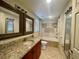 Bathroom featuring granite countertop vanity and shower-tub combo at 902 Estelle Ave, Brandon, FL 33511