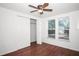 Bright bedroom features hardwood floors, ceiling fan, double door closet and window at 902 Estelle Ave, Brandon, FL 33511