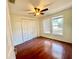 Bright bedroom features hardwood floors, ceiling fan, double door closet and window at 902 Estelle Ave, Brandon, FL 33511