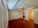A spacious bedroom with hardwood floors, ceiling fan, and views to bathroom and closet at 902 Estelle Ave, Brandon, FL 33511