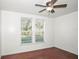 A bedroom featuring two windows with white trim and a ceiling fan at 902 Estelle Ave, Brandon, FL 33511