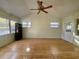 Bright bonus room with hardwood floors, a ceiling fan, shelving and backyard access at 902 Estelle Ave, Brandon, FL 33511