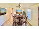 This dining room is virtually staged with a round table and a colorful piece of artwork on the wall at 902 Estelle Ave, Brandon, FL 33511