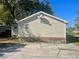 Exterior side view of a home showing the siding and driveway at 902 Estelle Ave, Brandon, FL 33511