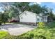 Exterior view shows the side and back of the house with a grassy yard and driveway at 902 Estelle Ave, Brandon, FL 33511