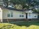 Charming one-story home featuring a covered front porch, well-manicured lawn and natural surroundings at 902 Estelle Ave, Brandon, FL 33511