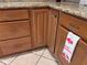 Close-up of the kitchen cabinets and granite countertop featuring dark wooden cabinets and handles at 902 Estelle Ave, Brandon, FL 33511