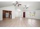 Spacious living room with tile floors, large windows, and a view into the modern kitchen at 902 Estelle Ave, Brandon, FL 33511