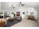 Open-concept living room with tile flooring, modern furniture, and adjacent dining area at 902 Estelle Ave, Brandon, FL 33511