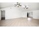 Large living room with tile flooring, vaulted ceilings and two ceiling fans at 902 Estelle Ave, Brandon, FL 33511