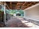 Brick-paved patio offering a shaded outdoor area, with views of the expansive backyard and sheds at 902 Estelle Ave, Brandon, FL 33511