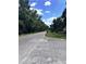 Street view showcases treelined road leading to home at 902 Estelle Ave, Brandon, FL 33511