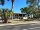 Inviting single-story home with a screened porch, surrounded by mature trees and manicured landscaping for a serene setting at 101 W Saint Johns Way, Apollo Beach, FL 33572