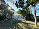 Wide view of the backyard and patio area enhanced by mature tropical landscaping at 1039 N Missouri Ave, Clearwater, FL 33755