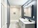 Modern bathroom with a double vanity, marble countertops, and a tiled shower-tub combo at 1039 N Missouri Ave, Clearwater, FL 33755