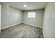 Neutral bedroom with natural light and gray laminate flooring throughout at 1039 N Missouri Ave, Clearwater, FL 33755