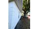 Exterior view of the home with white stucco walls and a large tree providing shade at 1039 N Missouri Ave, Clearwater, FL 33755