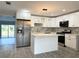 Modern kitchen with stainless steel appliances, white cabinets, and an island at 1039 N Missouri Ave, Clearwater, FL 33755