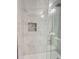 Beautiful shower features marble-look tile, a built-in niche, and glass enclosure at 1039 N Missouri Ave, Clearwater, FL 33755