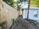 Side yard with privacy fence and a well maintained walkway at 1039 N Missouri Ave, Clearwater, FL 33755