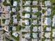 Aerial view of a neighborhood with lush landscaping, showcasing the home's location and surroundings at 112 79Th St # B, Holmes Beach, FL 34217