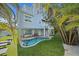 Stunning backyard with a refreshing pool, manicured lawn, and tropical landscaping that creates a private oasis at 112 79Th St # B, Holmes Beach, FL 34217