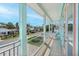 Charming balcony view with white railings showcasing a peaceful street and tropical landscaping at 112 79Th St # B, Holmes Beach, FL 34217