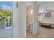 Bathroom view from doorway showing water closet and Primary bedroom at 112 79Th St # B, Holmes Beach, FL 34217