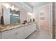Bathroom featuring a long vanity with granite countertops and a view of the glass shower at 112 79Th St # B, Holmes Beach, FL 34217