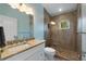 Bathroom with a glass-enclosed shower and granite countertop vanity at 112 79Th St # B, Holmes Beach, FL 34217