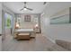 Inviting bedroom featuring a light color palette, tile floors, and a decorative bench at 112 79Th St # B, Holmes Beach, FL 34217