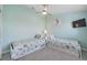 Light and airy bedroom with ceiling fan, two twin beds, and tiled floors at 112 79Th St # B, Holmes Beach, FL 34217