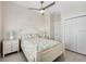 Bedroom with ceiling fan, tiled floors, closet, and side tables at 112 79Th St # B, Holmes Beach, FL 34217