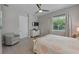 Bright bedroom with a ceiling fan, a patterned bedspread, and a view of the window at 112 79Th St # B, Holmes Beach, FL 34217
