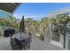 Outdoor deck with seating and grill surrounded by lush tropical landscaping at 112 79Th St # B, Holmes Beach, FL 34217
