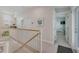 Hallway with staircase, railing, and tile floors leading to a bedroom at 112 79Th St # B, Holmes Beach, FL 34217
