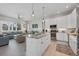 Open kitchen and living space featuring a central island, stainless steel appliances, and comfortable seating at 112 79Th St # B, Holmes Beach, FL 34217