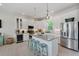 Elegant kitchen with a center island, stainless steel appliances, and sleek white cabinetry, ideal for culinary enthusiasts at 112 79Th St # B, Holmes Beach, FL 34217