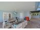 Covered patio with comfortable seating, a ceiling fan, and outdoor games for entertainment at 112 79Th St # B, Holmes Beach, FL 34217