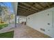 Covered patio area featuring brick pavers, an outdoor shower, and access to the backyard at 112 79Th St # B, Holmes Beach, FL 34217