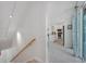 Staircase leading to an open-concept living area with a bright kitchen, enhancing the home's modern design at 112 79Th St # B, Holmes Beach, FL 34217