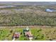 An aerial view of the residence with a pool adjacent to a wetland area at 1145 Boundary Blvd, Rotonda West, FL 33947